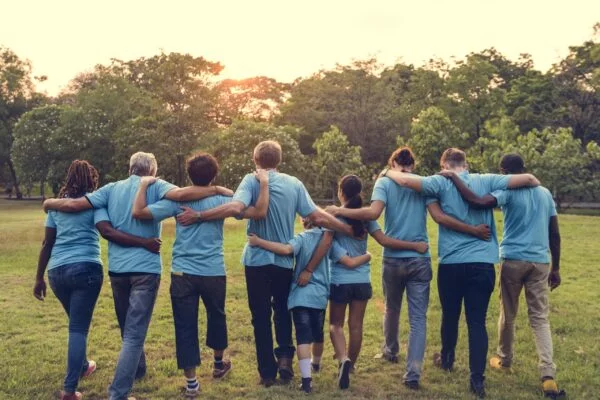 Group of diversity people volunteer arm around